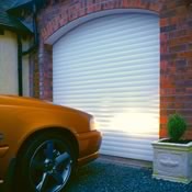 Insulated roller garage door in white fitted to an arched garage